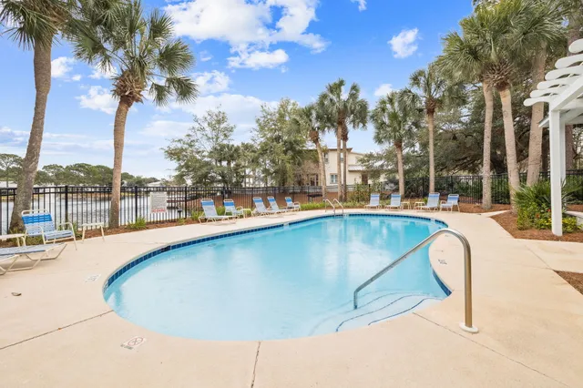 a view of a balcony with wooden floor and seating