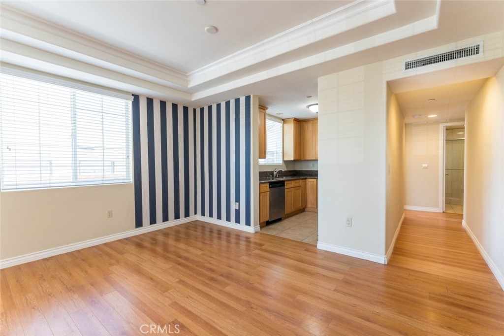 511 East Harvard Road, Unit 101 Burbank, CA 91501 - Photo 8 of 29 a view of a kitchen with wooden floor and electronic appliances