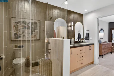 a bathroom with a double vanity sink and a mirror