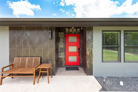 a front view of a house with outdoor seating