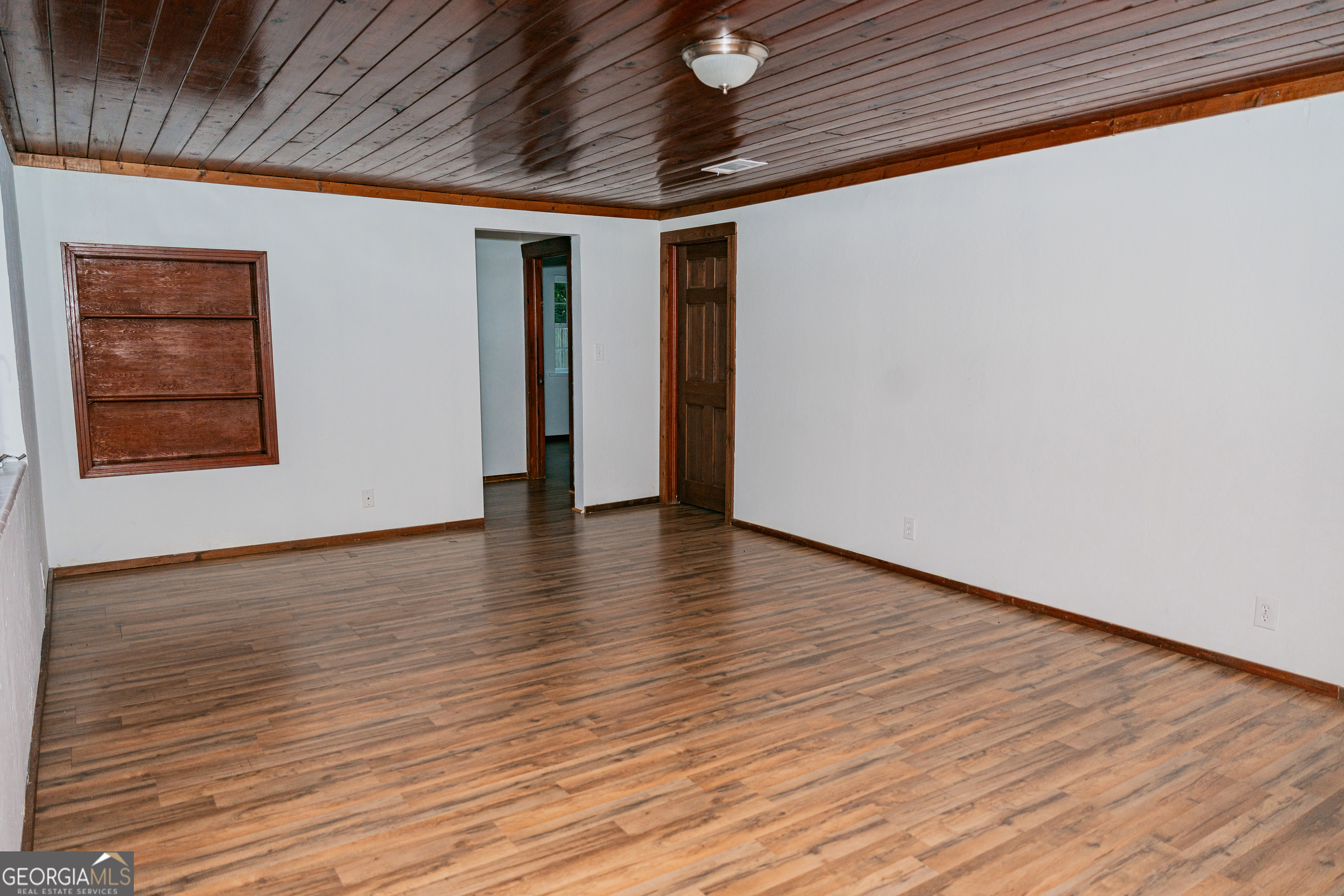 4427 Pine Valley Road Waycross, GA 31503 - Photo 12 of 24 a view of an empty room with wooden floor and a window