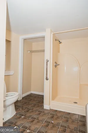 a bathroom with a shower and a toilet