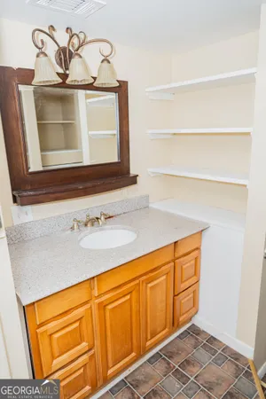 a bathroom with a sink and a mirror
