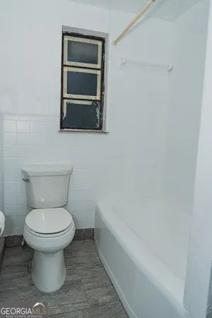 a bathroom with a toilet and a bathtub