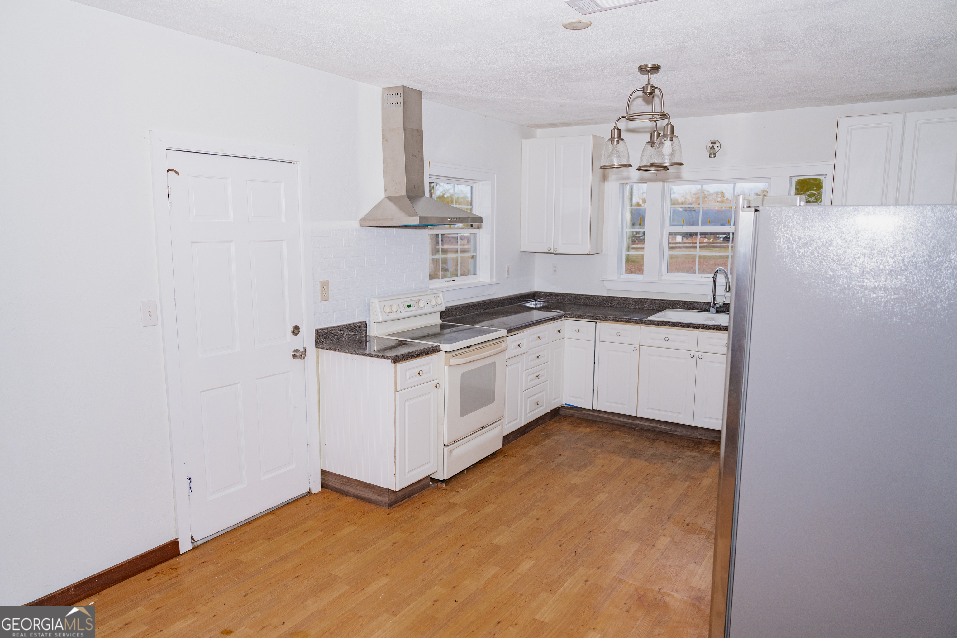 4427 Pine Valley Road Waycross, GA 31503 - Photo 9 of 24 a kitchen with granite countertop a sink and cabinets