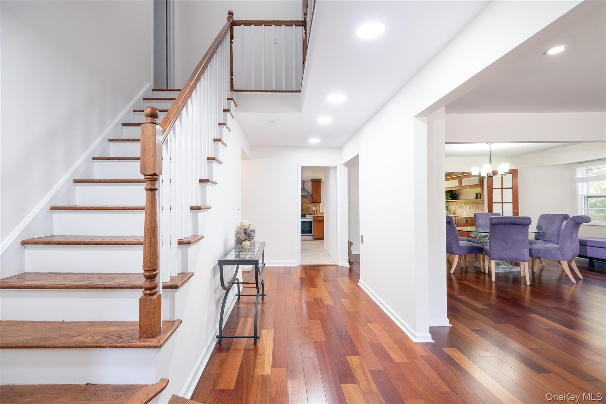 24 Sheldrake Place New Rochelle, NY 10804 - Photo 10 of 26 Stairway with a chandelier, hardwood / wood-style flooring, recessed lighting, and baseboards