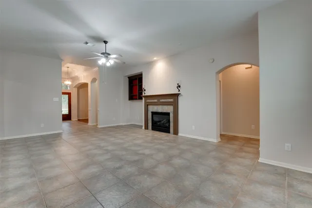a view of a livingroom with a ceiling fan window and a fireplace