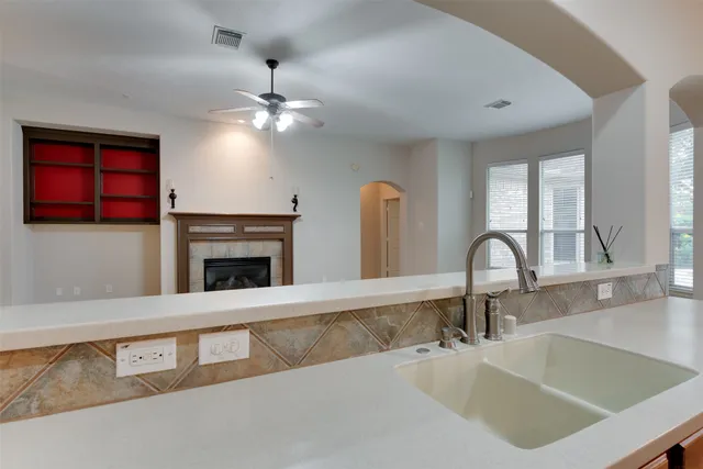 a kitchen with a sink and a fireplace