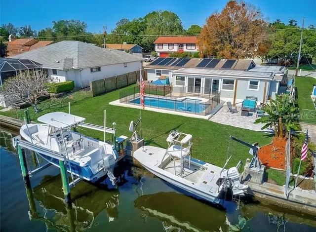 a view of house with a yard from a patio