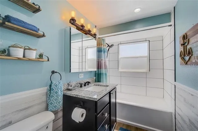 a bathroom with a sink toilet and vanity