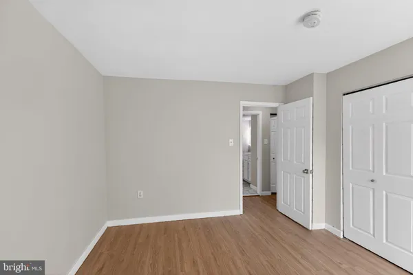 a view of wooden floor and windows in a room