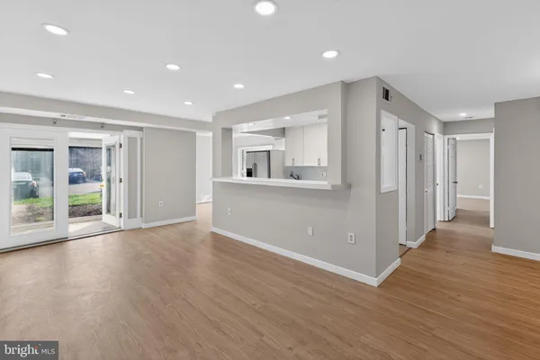 a view of wooden floor and windows in an empty room