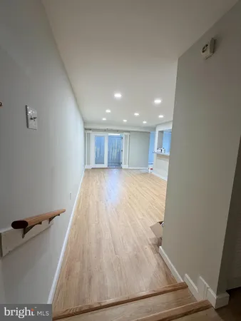 a view of a room with wooden floor