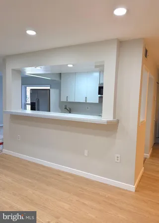 an empty room with wooden floor and a window