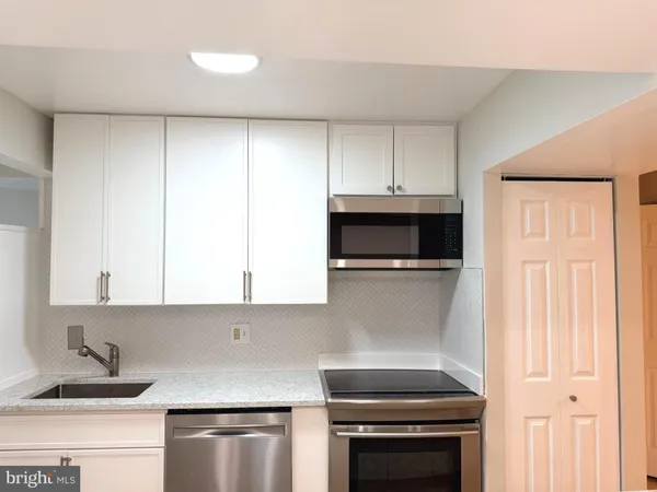 a kitchen with a sink and a microwave