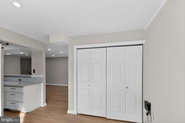 a view of a hallway with cabinet and mirror