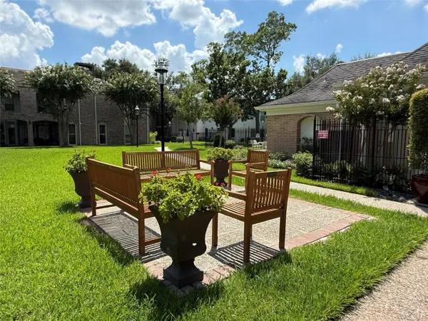 a swimming pool with outdoor seating and yard