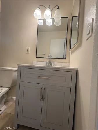 a bathroom with a sink a mirror and a light fixture
