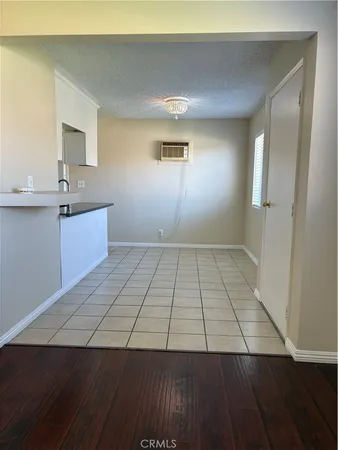 wooden floor in a room with a mirror and a wooden floor