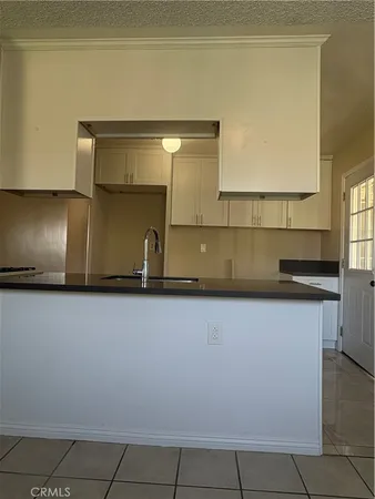 a kitchen with a sink a counter top space and cabinets