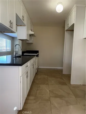 a kitchen that has a sink and a stove