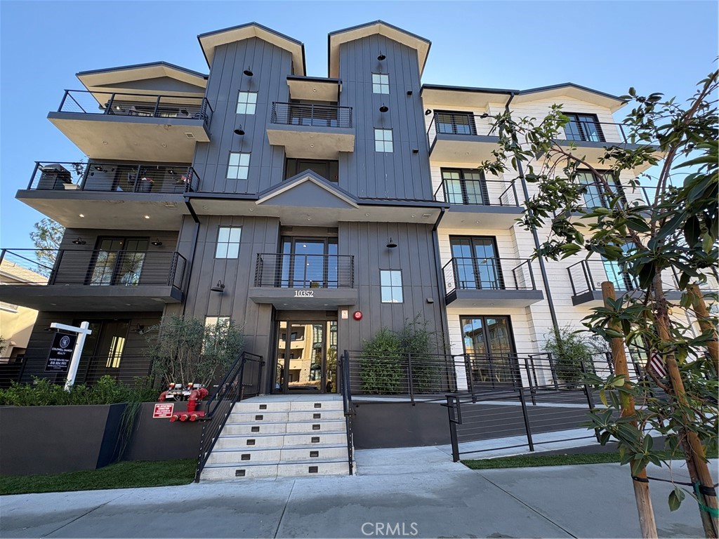 10352 Riverside Drive, Unit 201 Toluca Lake, CA 91602 - Photo 1 of 49 a front view of a brick building with many windows