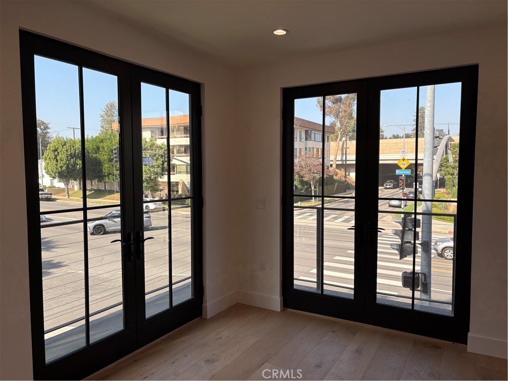 10352 Riverside Drive, Unit 201 Toluca Lake, CA 91602 - Photo 12 of 49 a view of an empty room with windows
