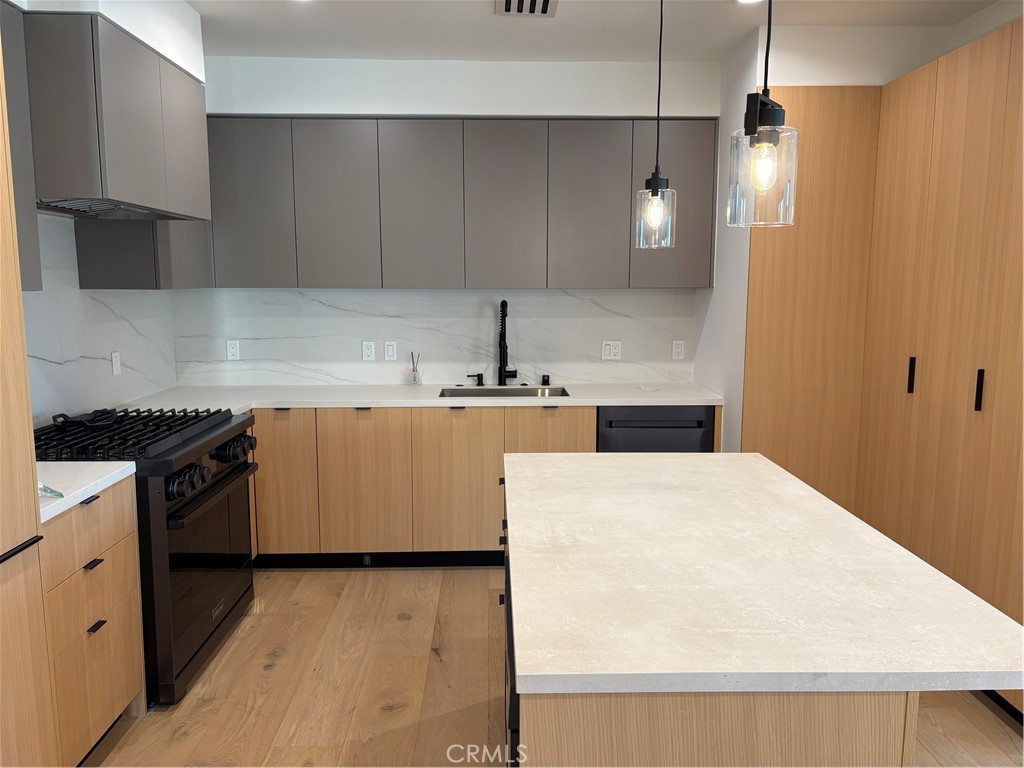 10352 Riverside Drive, Unit 201 Toluca Lake, CA 91602 - Photo 14 of 49 a kitchen with a sink a stove and refrigerator