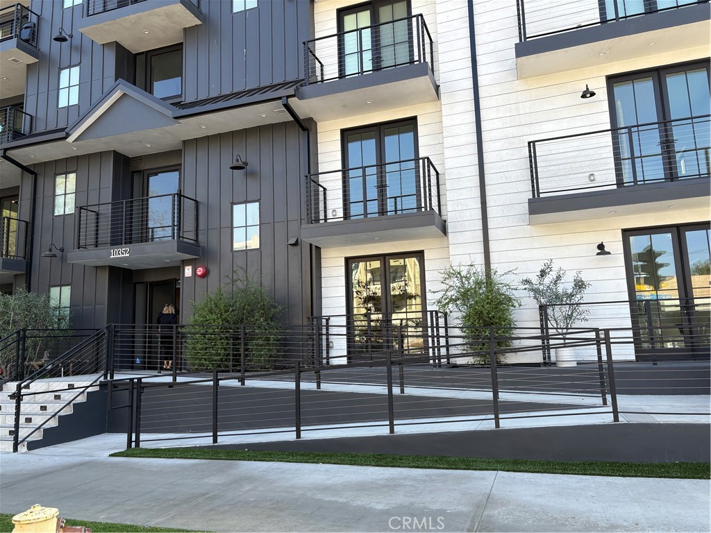 10352 Riverside Drive, Unit 201 Toluca Lake, CA 91602 - Photo 2 of 49 a view of a brick building with many windows