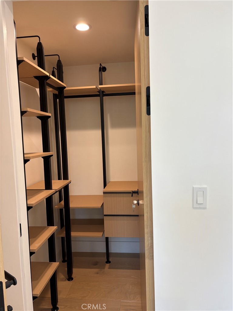 10352 Riverside Drive, Unit 201 Toluca Lake, CA 91602 - Photo 26 of 49 a view of walk in closet with clothes and shoes