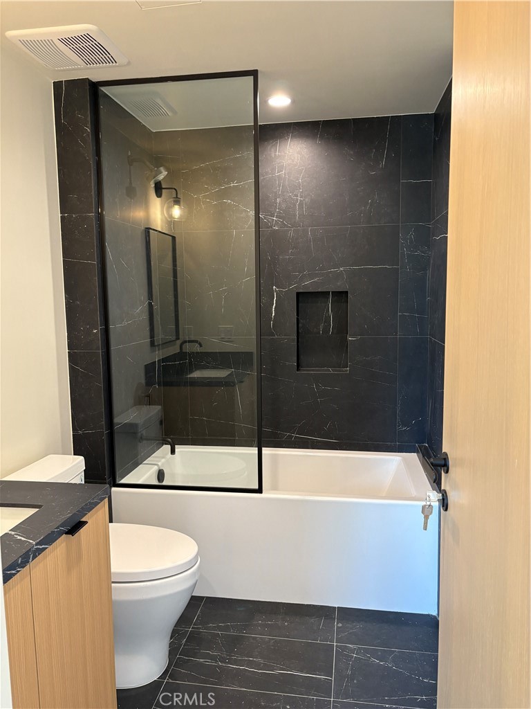 10352 Riverside Drive, Unit 201 Toluca Lake, CA 91602 - Photo 28 of 49 a bathroom with a bathtub and a shower