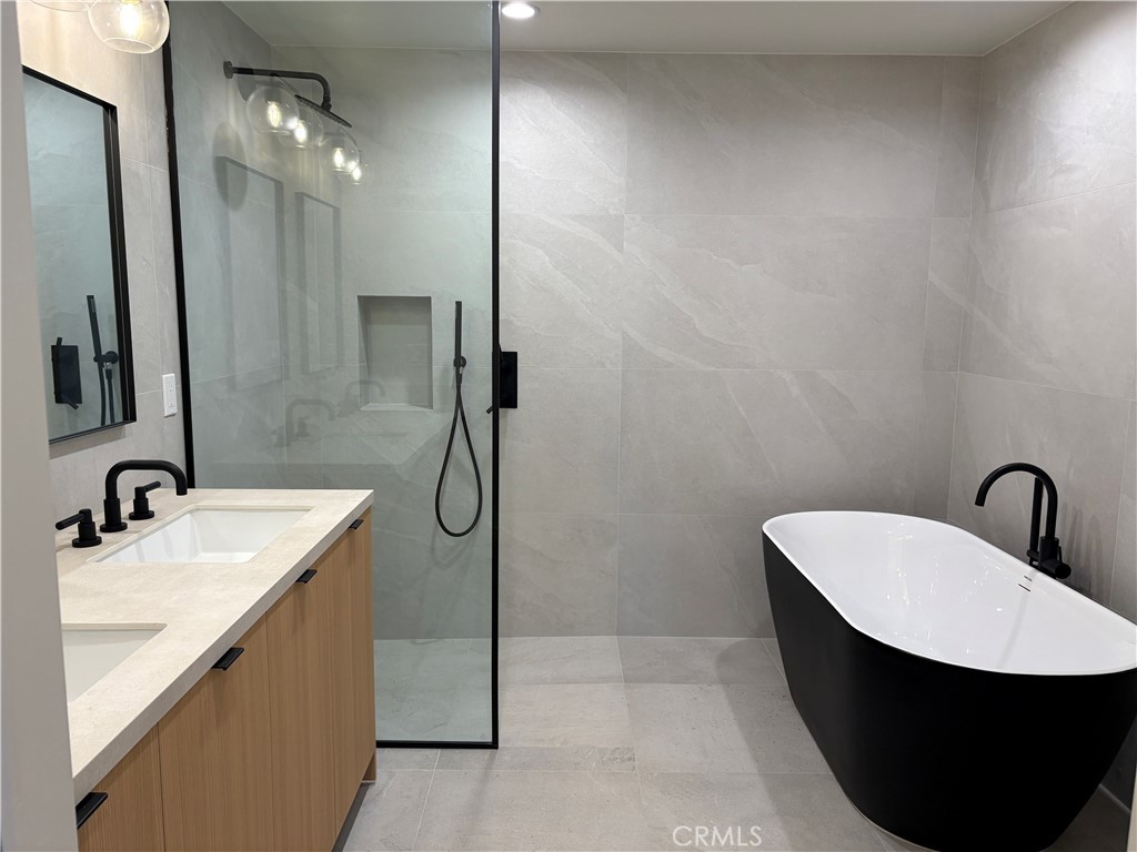 10352 Riverside Drive, Unit 201 Toluca Lake, CA 91602 - Photo 34 of 49 a bathroom with a sink a toilet a mirror and shower