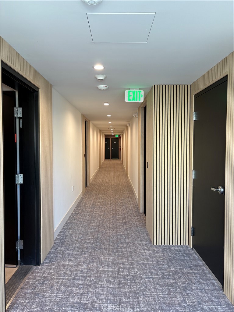10352 Riverside Drive, Unit 201 Toluca Lake, CA 91602 - Photo 4 of 49 a view of a hallway with wooden floor and windows