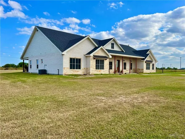 a house view with a swimming pool and garden space