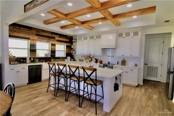 a large white kitchen with lots of counter space