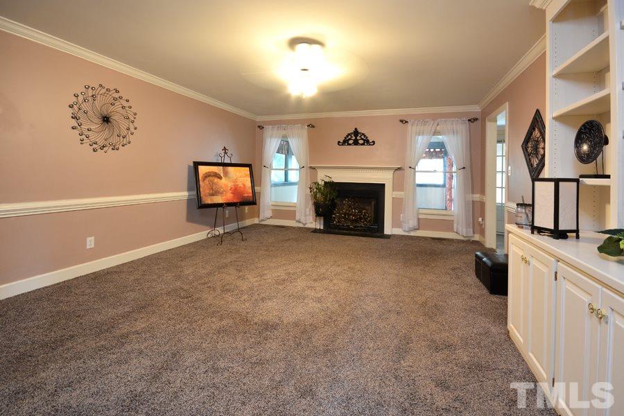 3723 Pickett Road Durham, NC 27705 - Photo 4 of 25 complete with built-ins and ceiling fan, as well as thermostat controlled gas log fireplace
