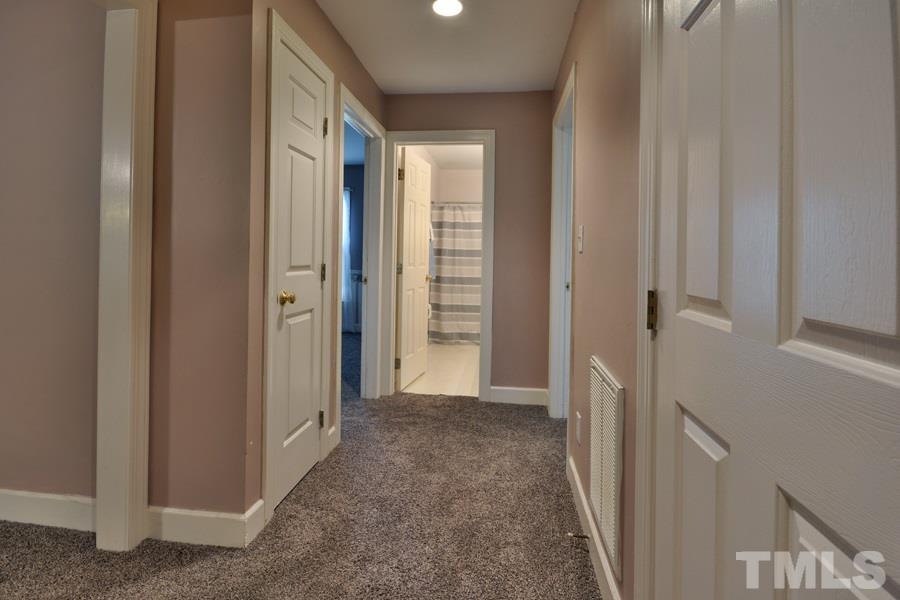 3723 Pickett Road Durham, NC 27705 - Photo 25 of 25 Space efficient hallway maximizes floorplan for functional purposes - 2 linen closets as well as double closet in this hall