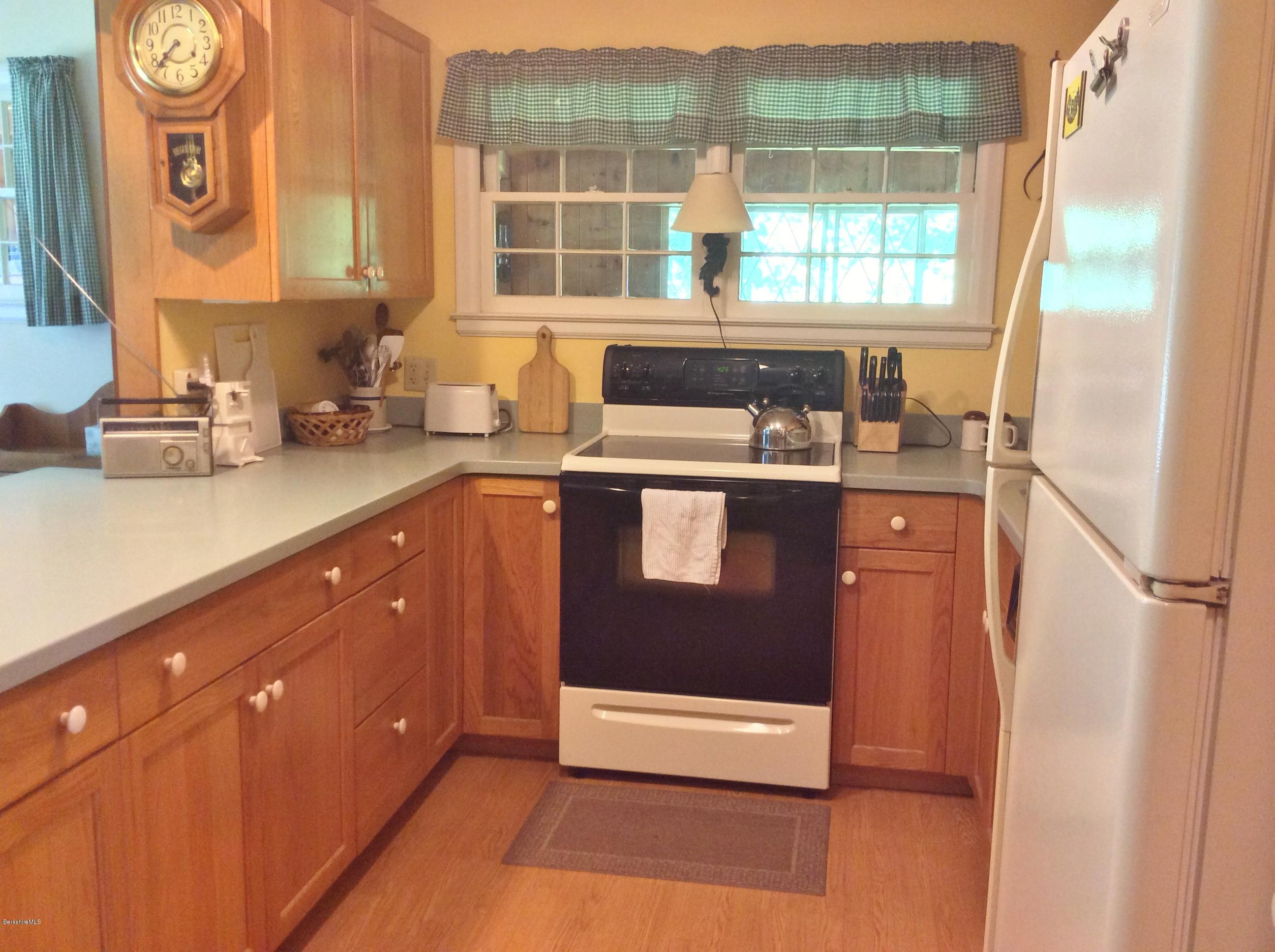 101 Patton Road Richmond, MA 01254 - Photo 8 of 23 a kitchen with stainless steel appliances granite countertop a sink and a granite counter tops with a large window