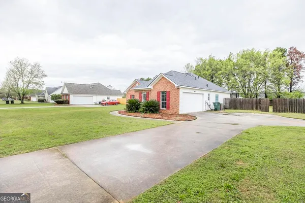 a front view of house with yard and green space