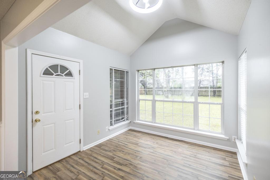 319 Smithville Church Road Warner Robins, GA 31088 - Photo 11 of 34 an empty room with wooden floor and windows
