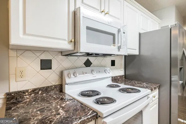 a kitchen with a stove and a refrigerator