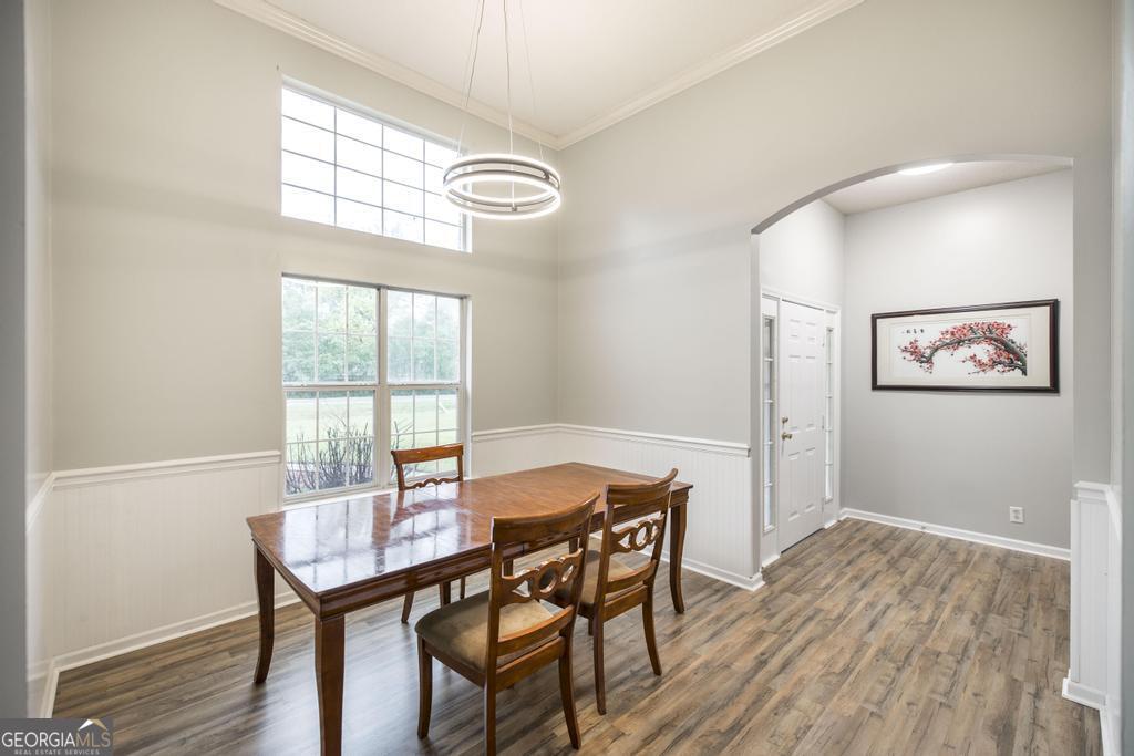 319 Smithville Church Road Warner Robins, GA 31088 - Photo 16 of 34 a view of a dining room with furniture a chandelier and wooden floor