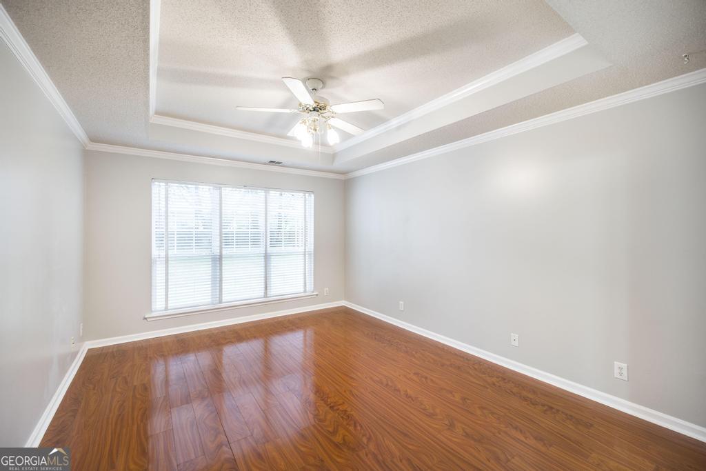 319 Smithville Church Road Warner Robins, GA 31088 - Photo 18 of 34 an empty room with wooden floor fan and windows