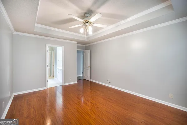 a view of an empty room with wooden floor