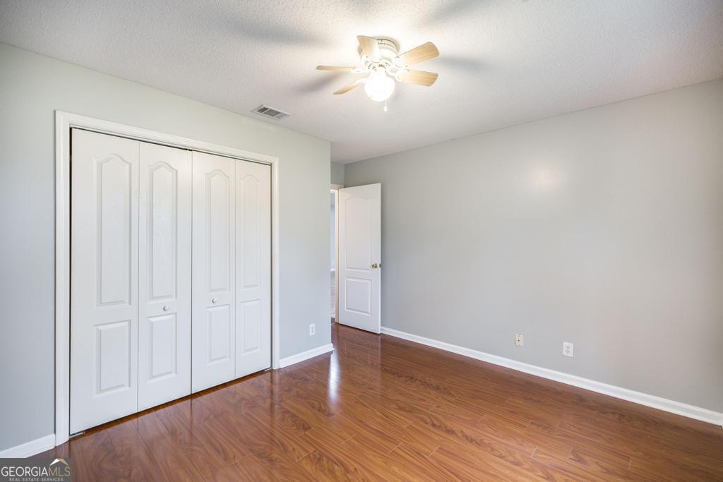 319 Smithville Church Road Warner Robins, GA 31088 - Photo 24 of 34 wooden floor in an empty room with a window