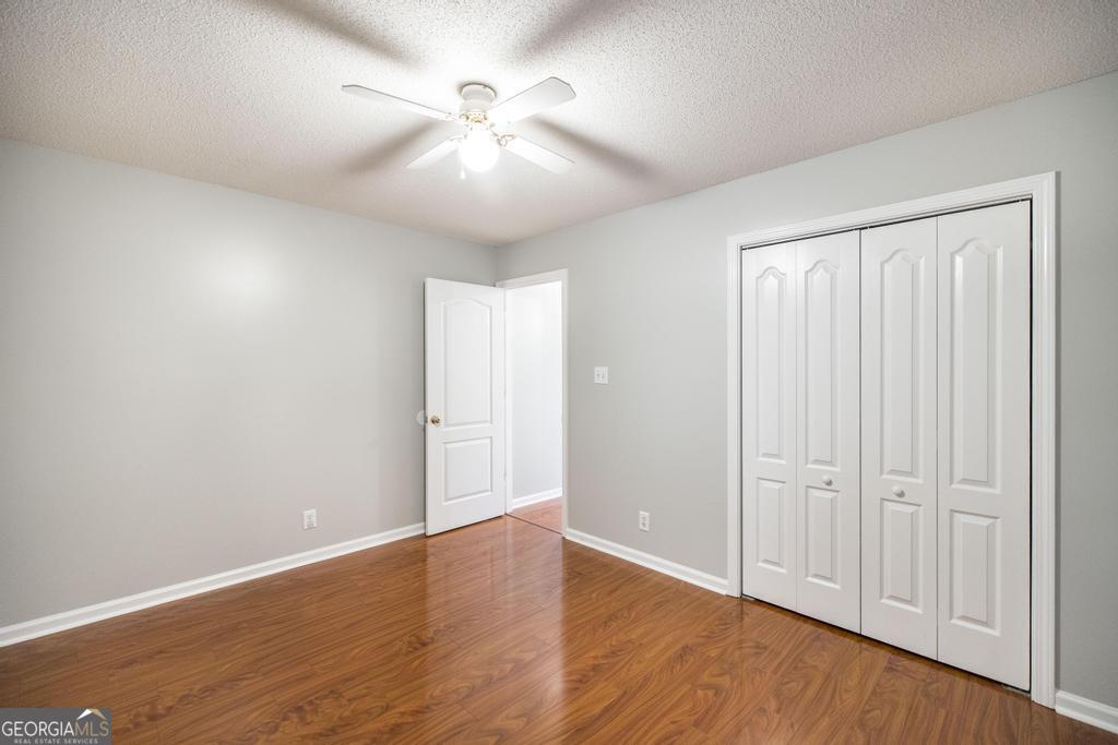 319 Smithville Church Road Warner Robins, GA 31088 - Photo 27 of 34 an empty room with wooden floor and windows