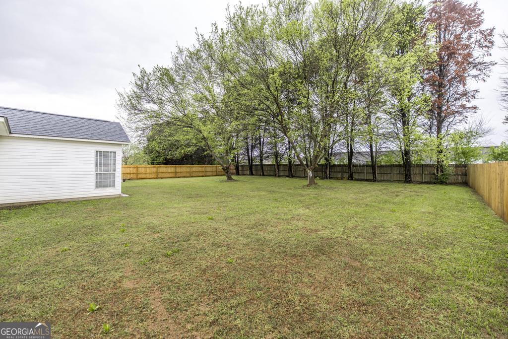 319 Smithville Church Road Warner Robins, GA 31088 - Photo 34 of 34 a view of a field with a trees in the background