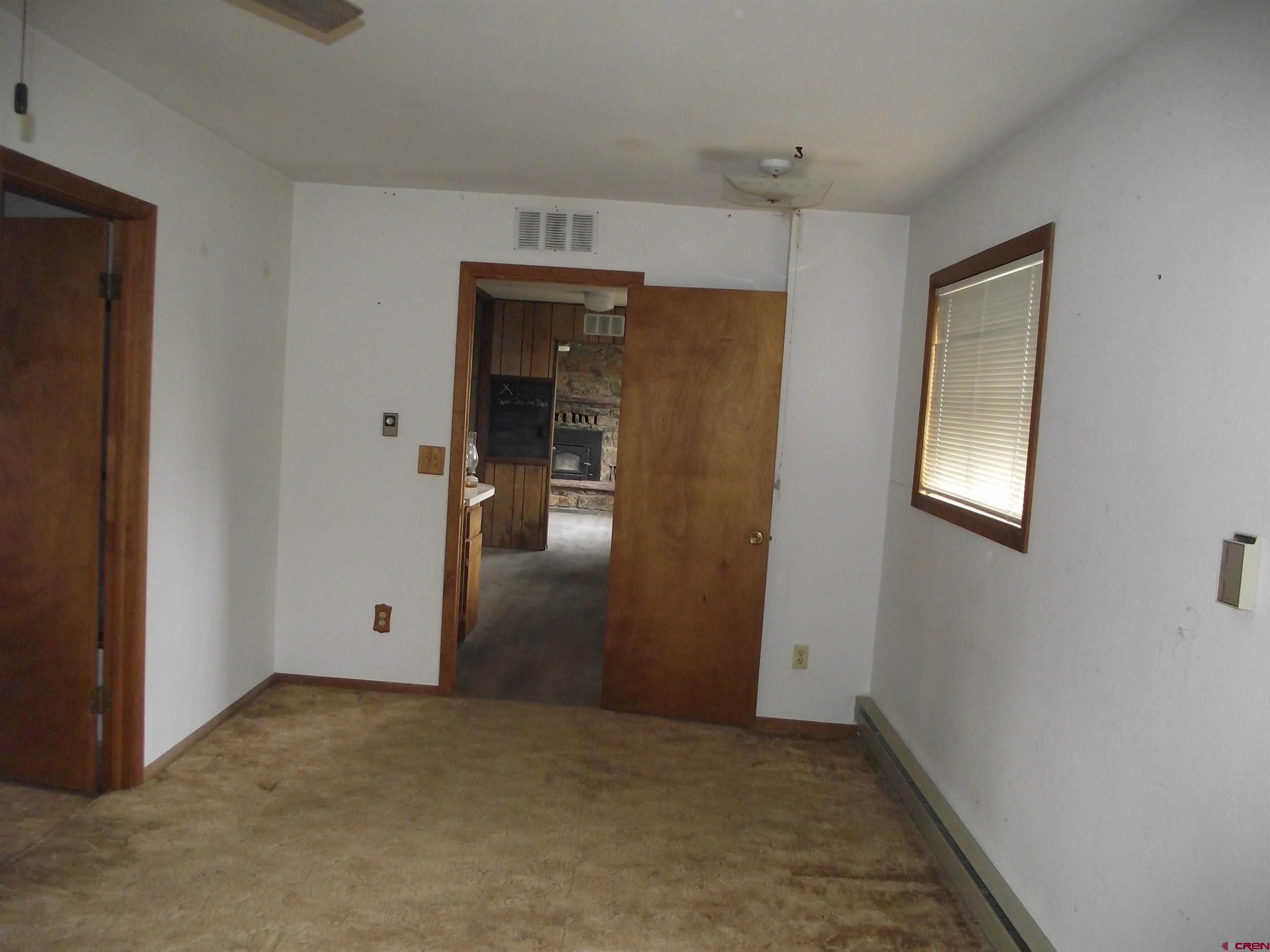 42996 Needle Rock Road Crawford, CO 81415 - Photo 28 of 45 an empty room with closet and windows
