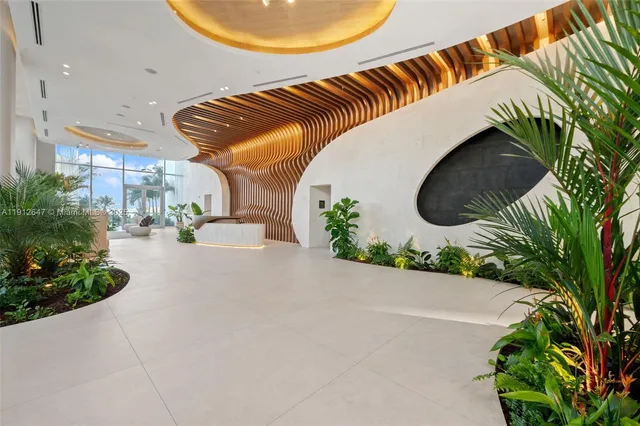 a front view of a house with a garden and plants