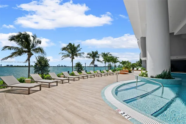 a view of empty room with wooden floor and windows